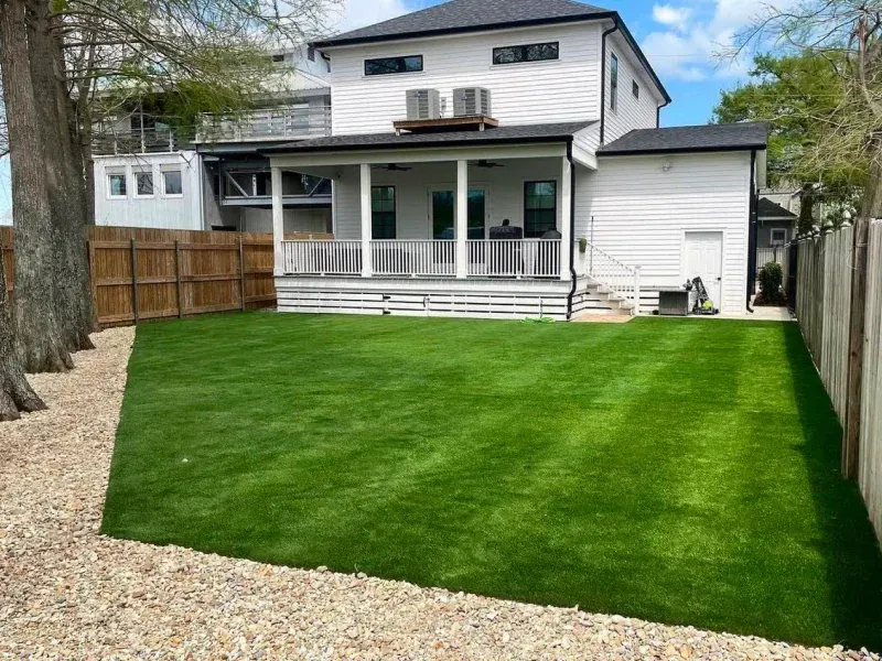 A large white house with a large lawn in front of it.