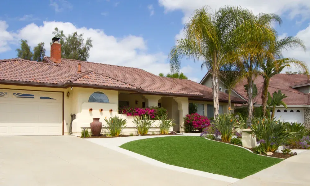 A house with a red tile roof and a white garage door