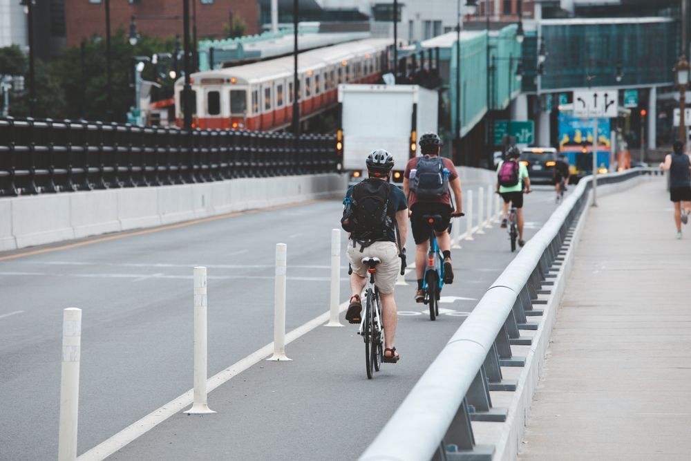 Cyclists riding to work across the Longfellow Bridge in Boston. Bike to Work Day