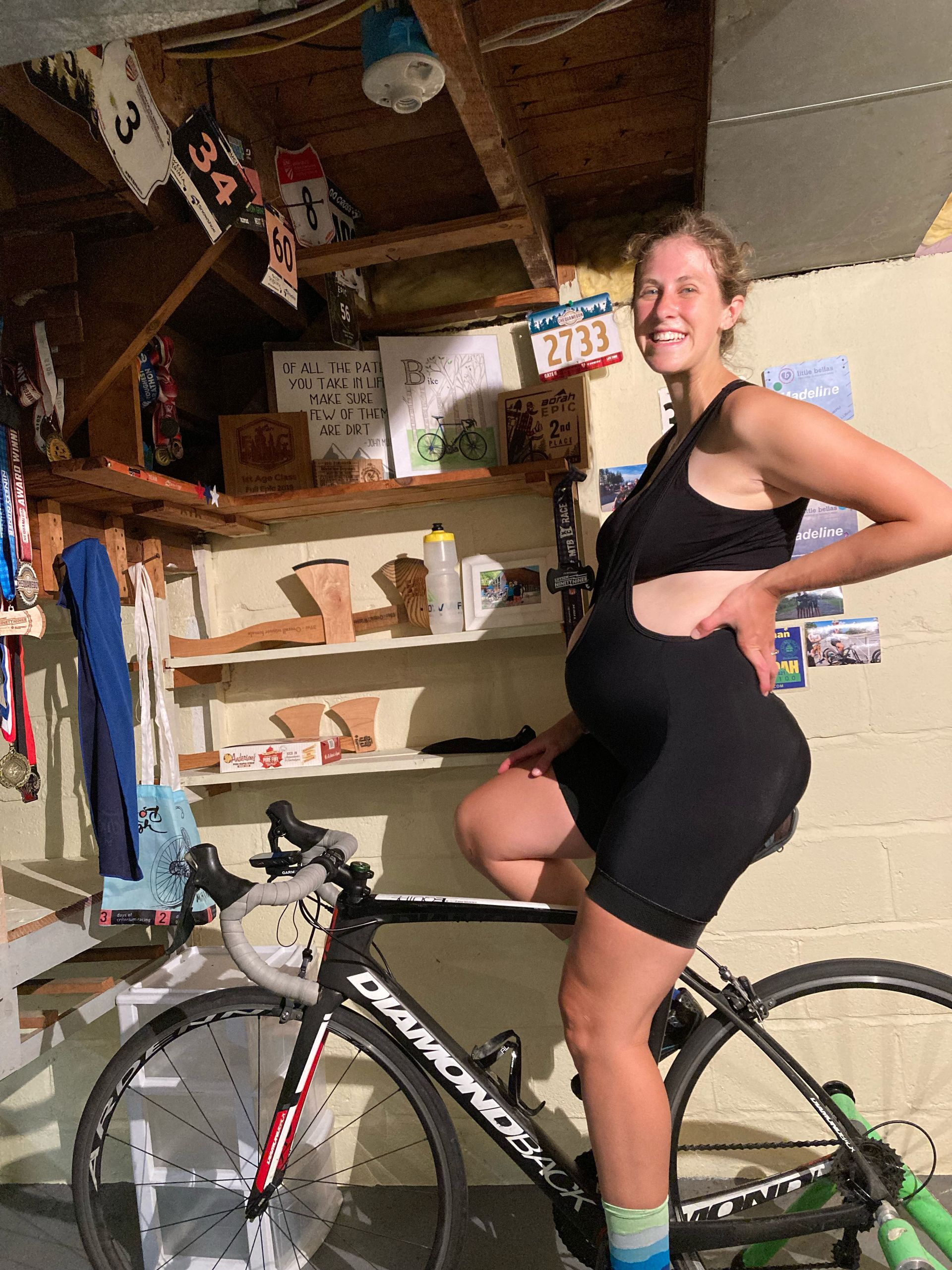 Pregnant woman on indoor bicycle trainer