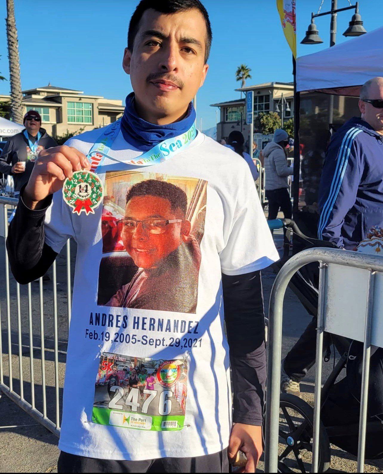 Man wearing a shirt with a printed face of a fellow bicycle rider