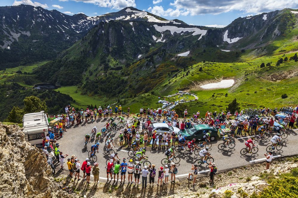 PORT DE PAILLERES,FRANCE- JUL 6: The peloton climbing the road to Col de Pailheres in Pyrenees Mountains during the stage 8 of the 100 edition of Le Tour de France on  July 6, 2013.
