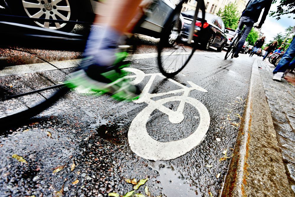 Cyclists riding in a bicycle lane on a busy urban street