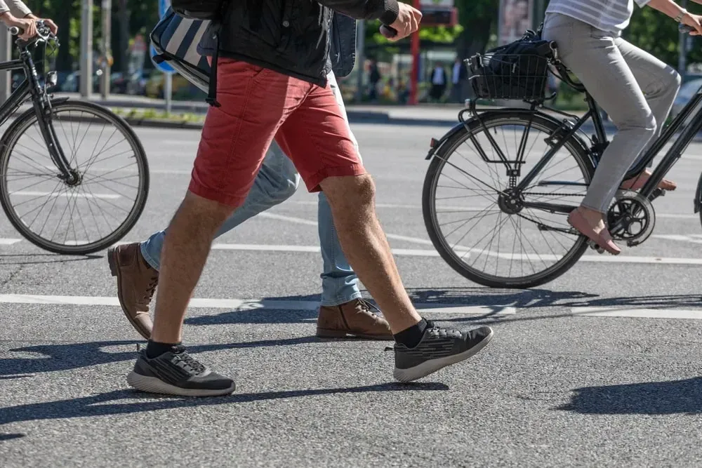 bicycles and pedestrians sharing a busy crosswalk