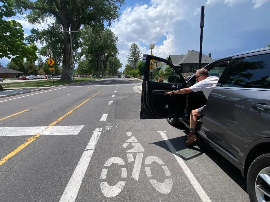 A driver opening a car door into a class II standard bicycle lane