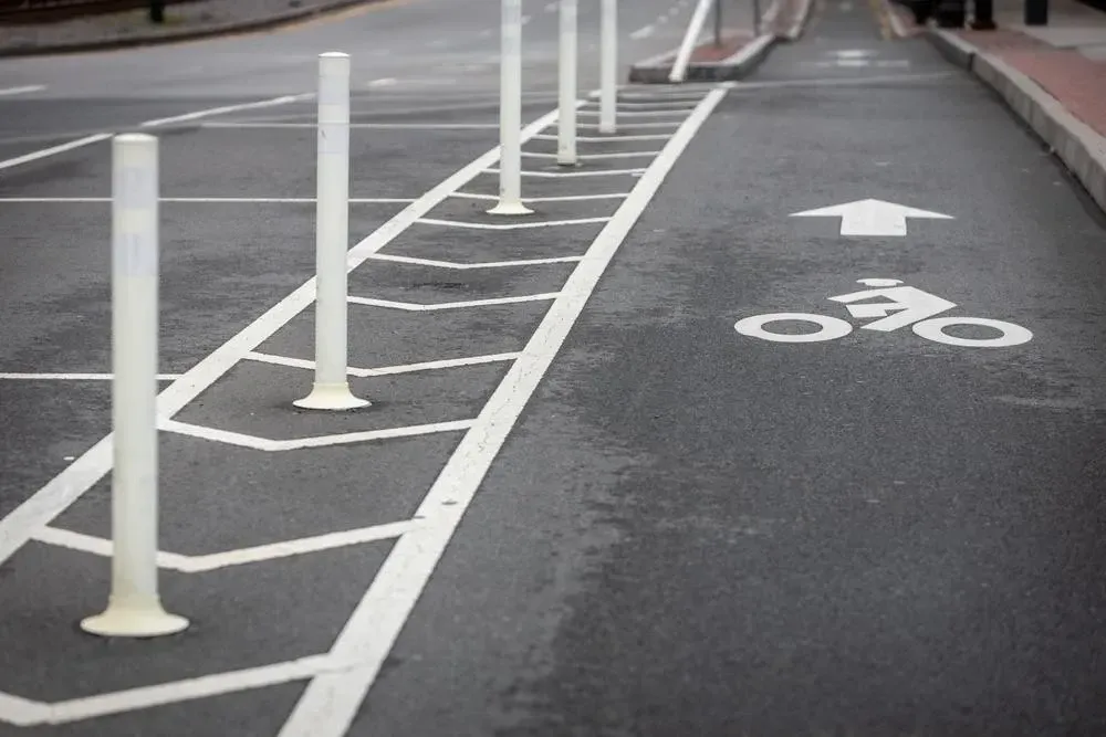 Class IV protected bike lane with flexible barriers to prevent vehicles from entering the bike lane.
