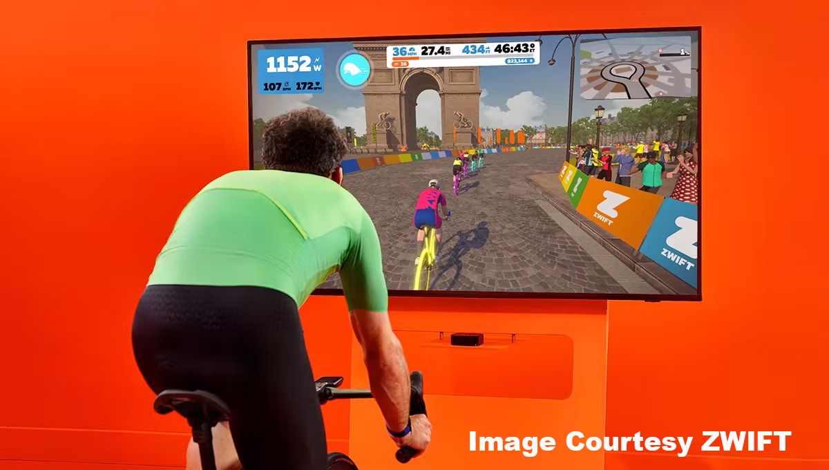 Cyclist on indoor trainer in front of a screen riding Zwift