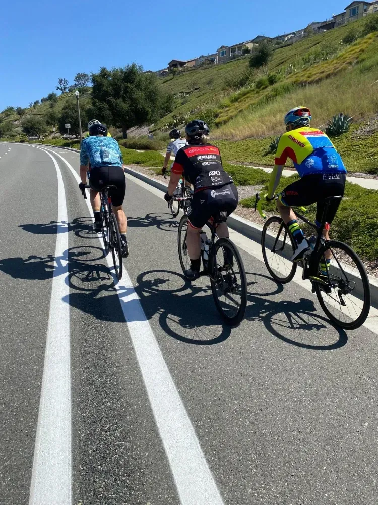 Five cyclists riding in a buffered bike lane in southern California