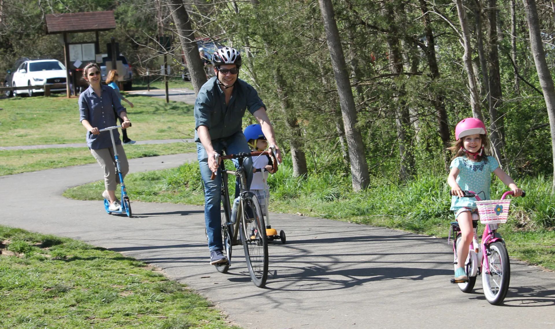 a family on bicycles on a multi-use bike path in North Carolina