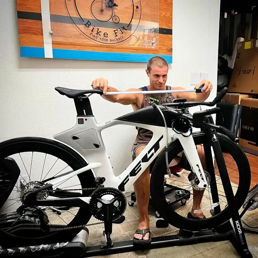 Nate Koch, expert bike fitter performing a measurement on a time trial bike in his Long Beach studio