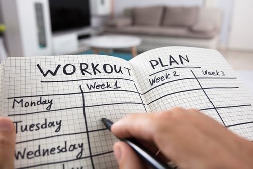 notebook with workout training plan