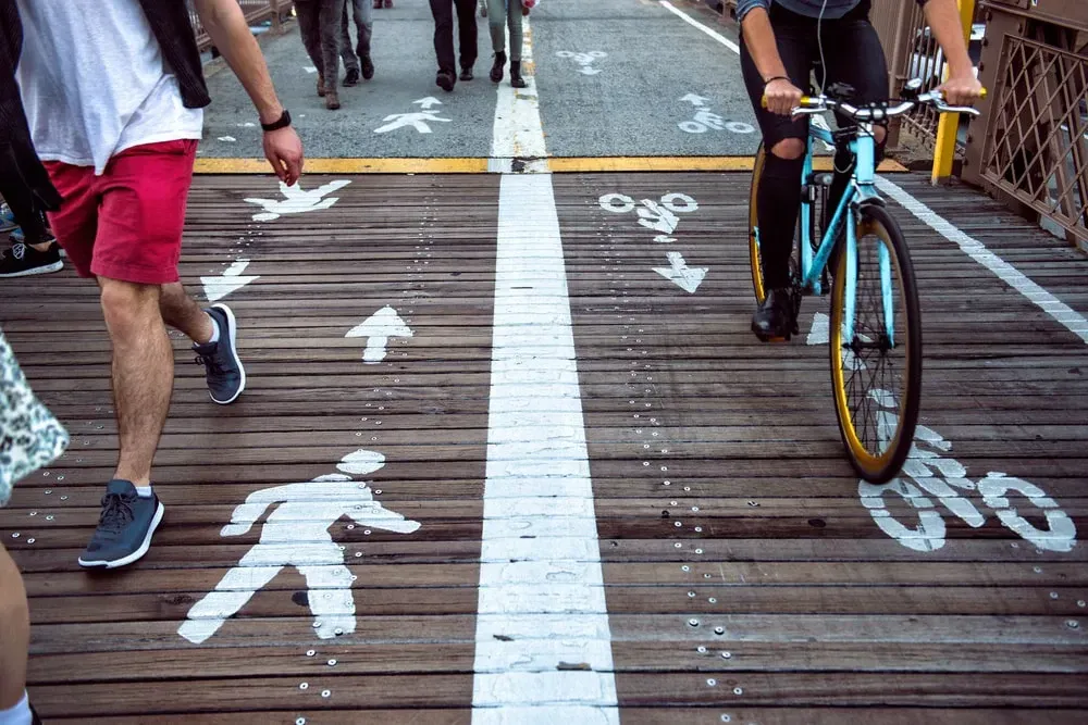 short bridge with distinct separate sides for bicycles and pedestrians indicated with white paint