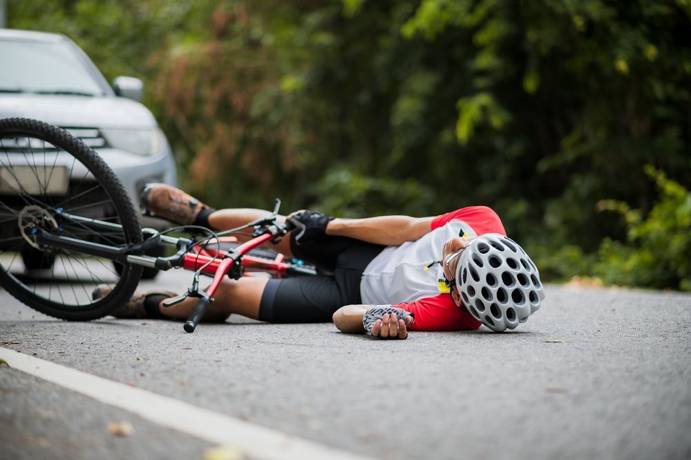 cyclist hit by car on ground