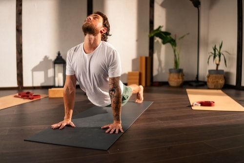 Young man practicing yoga on a mat