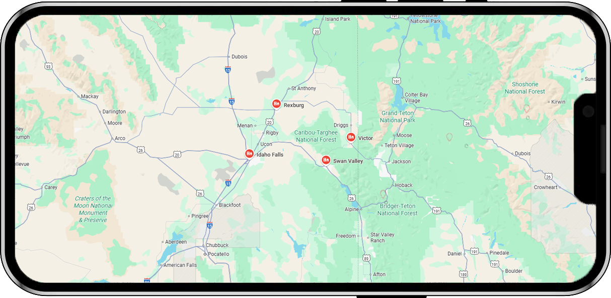 A phone displays a map with roads, mountains, and red location markers. A phone displays a map with roads, mountains, and red location markers.