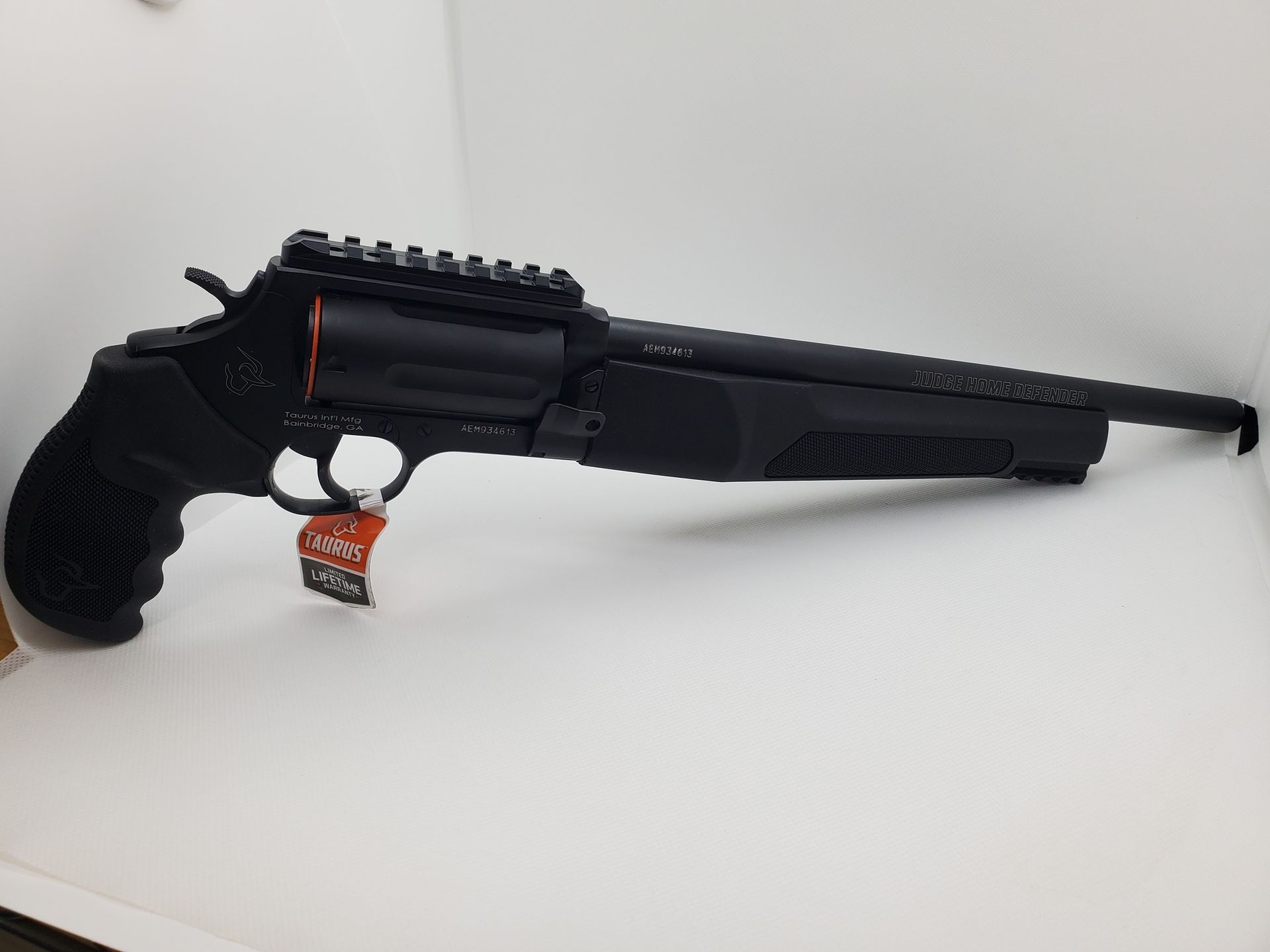 Black handgun-style firearm with long barrel and rail, shown on a white background