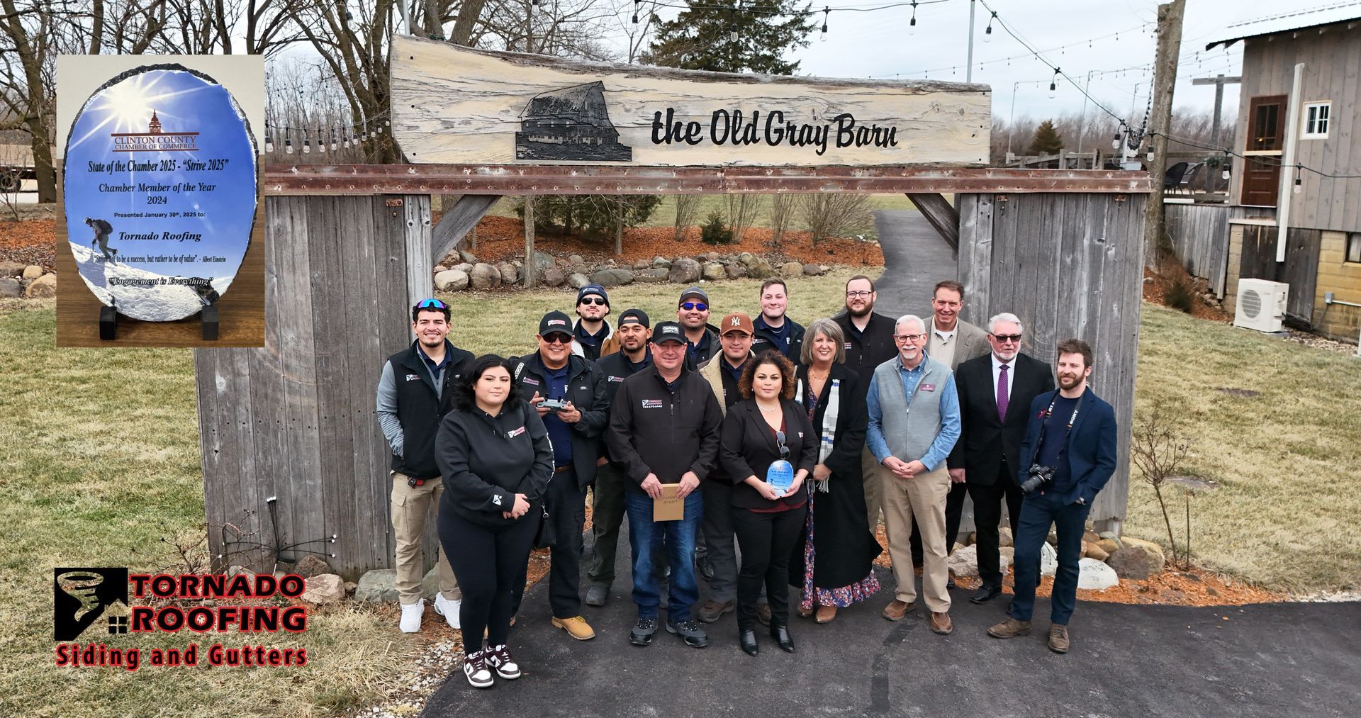 Group of people posing in front of weathered sign that says