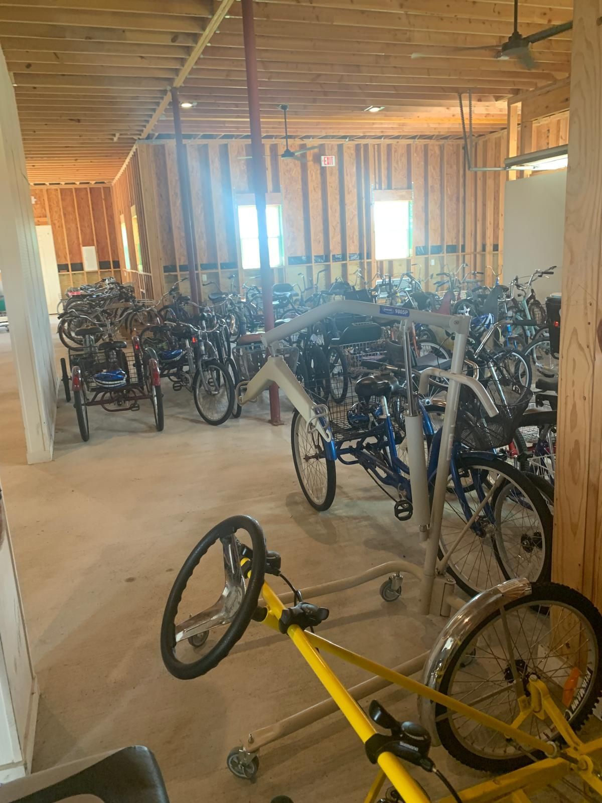 A bunch of bicycles are parked in a building.