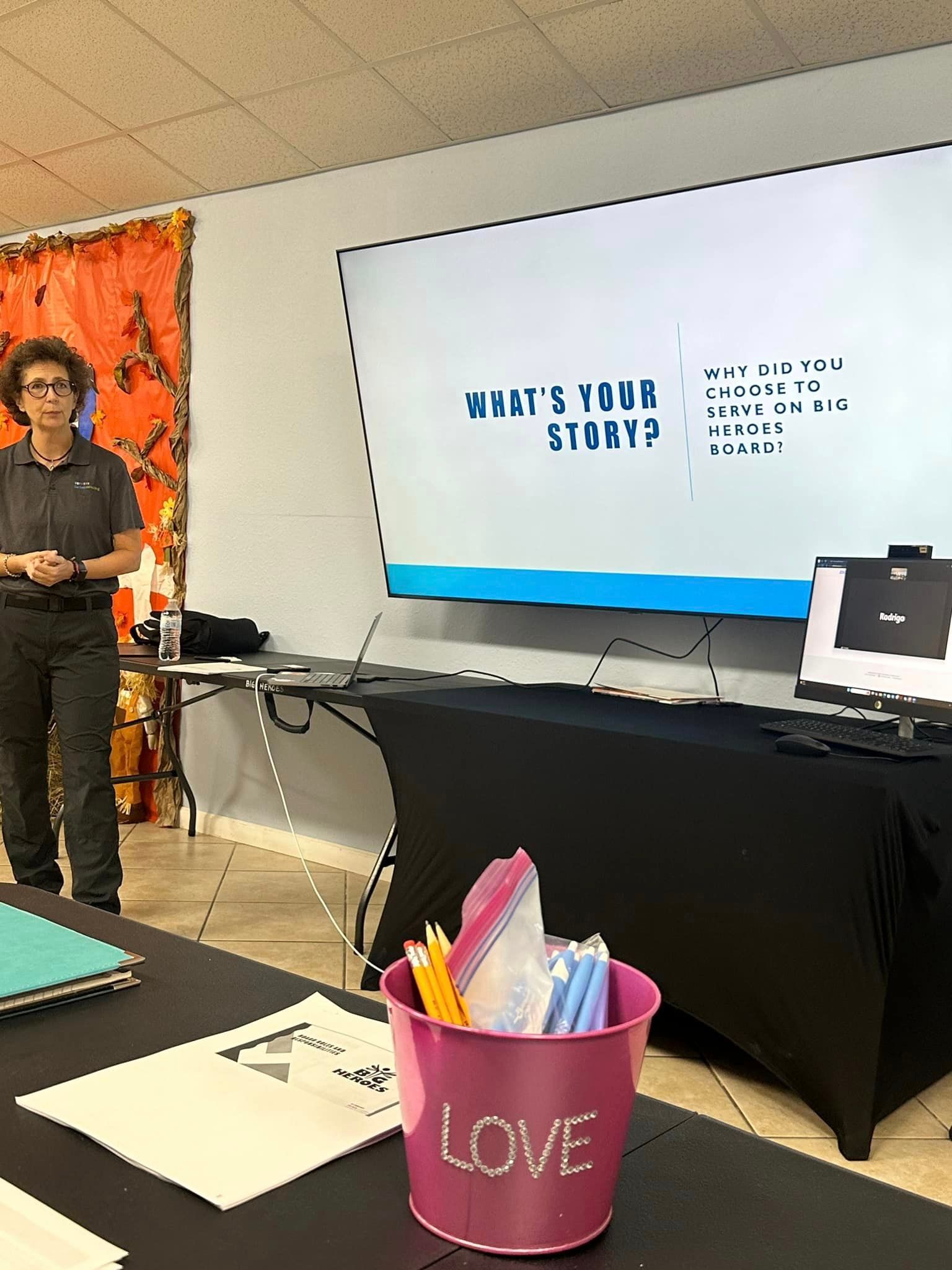 Woman at a presentation with a screen that says 