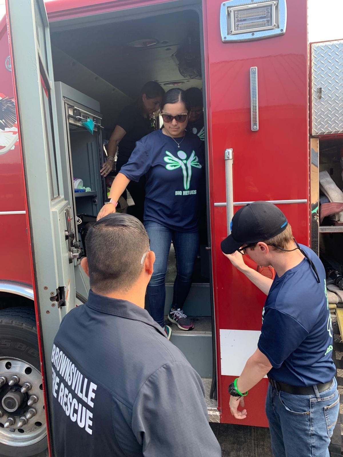 A group of people are getting out of an ambulance.
