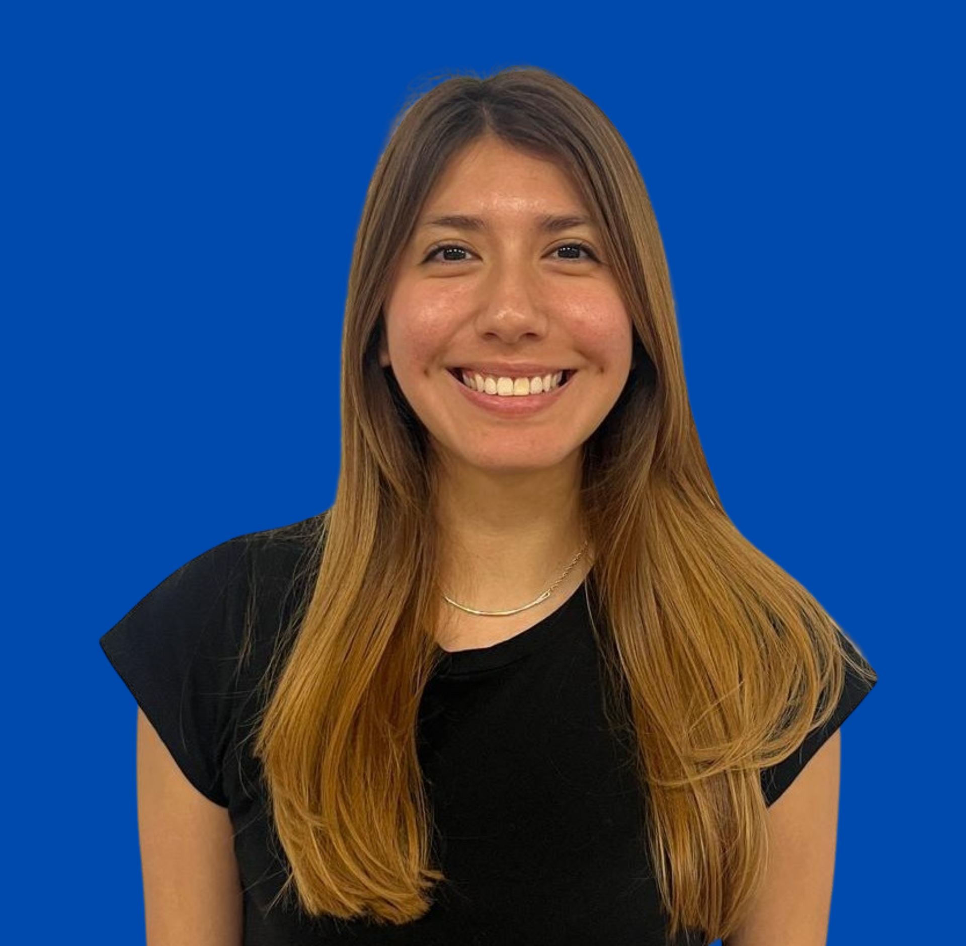 A woman in a black shirt is smiling in front of a blue background.