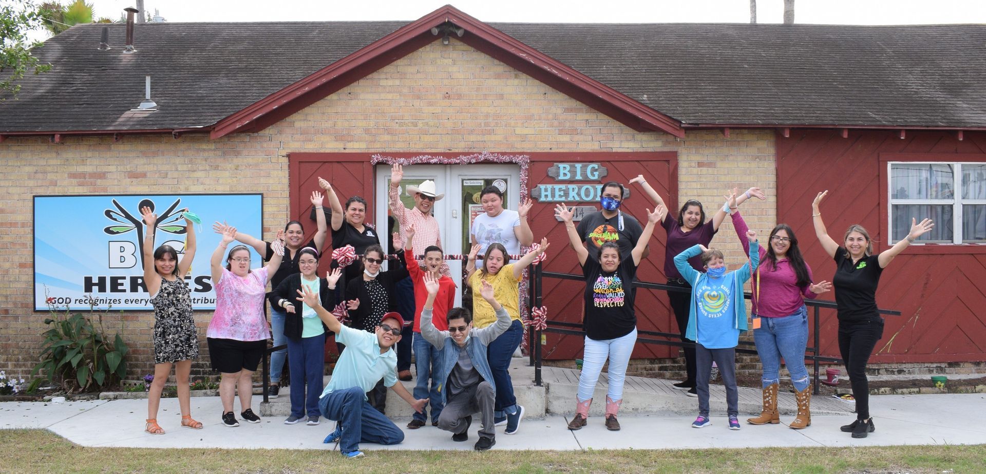 A group of people are posing for a picture in front of a building.