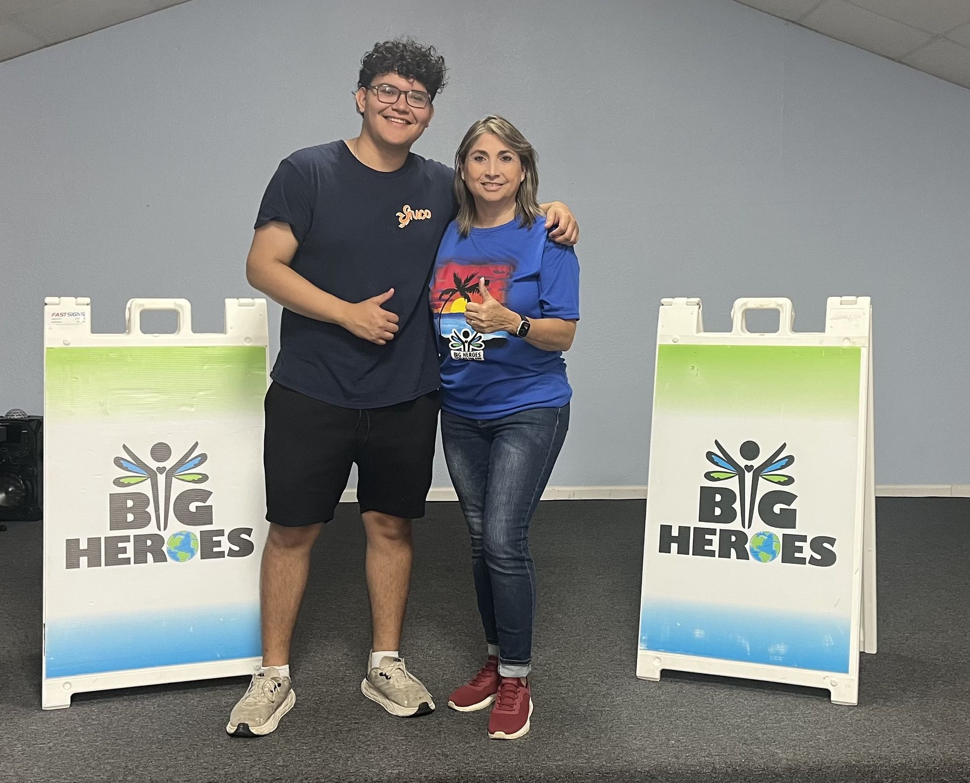 Two people pose with 