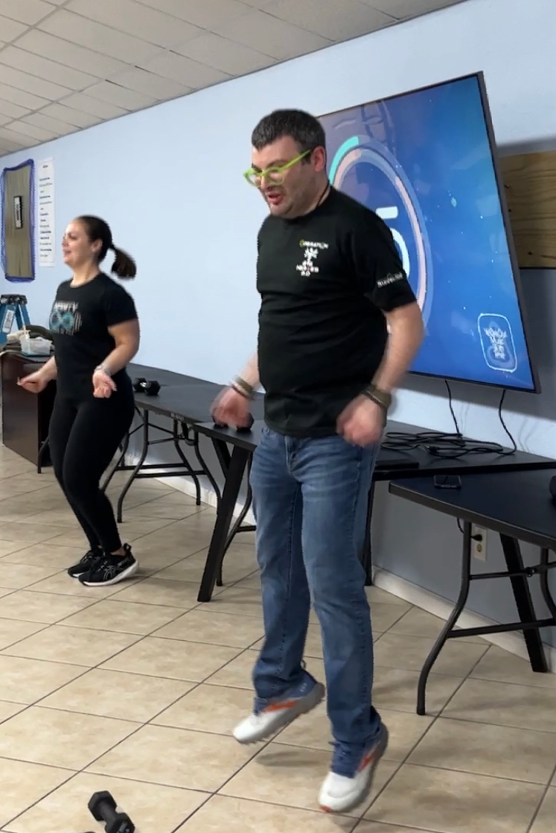 A man and a woman are dancing in a room.
