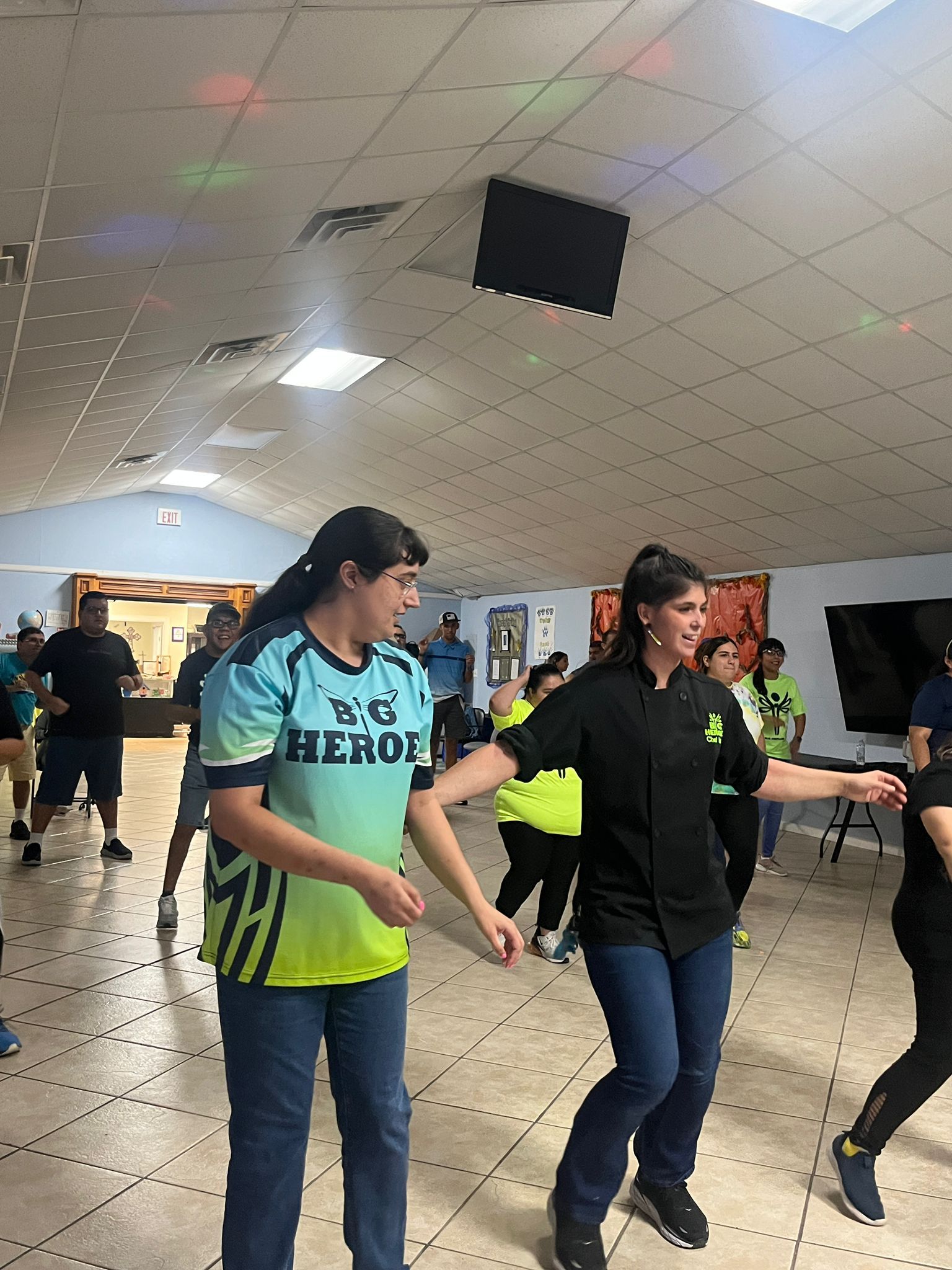 A group of people are dancing in a room.