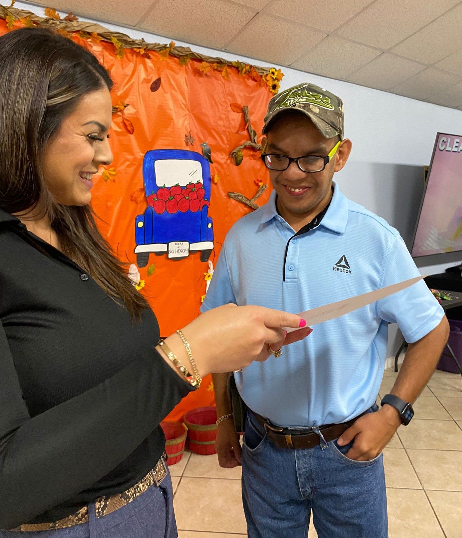 A man and a woman are looking at a piece of paper