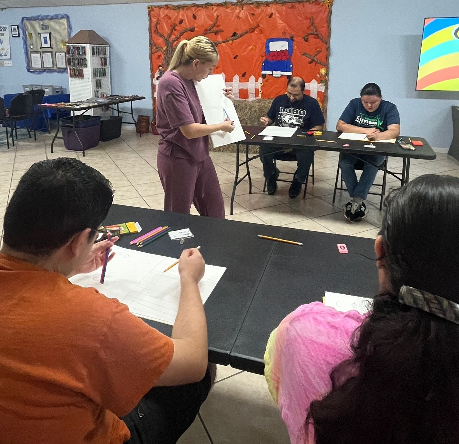 A group of people are sitting at tables in a room