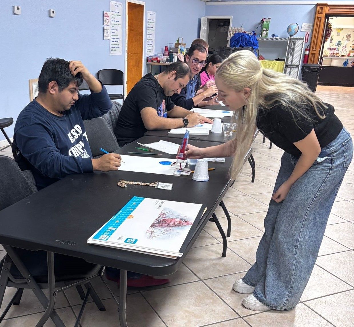 A group of people are sitting at tables in a room.