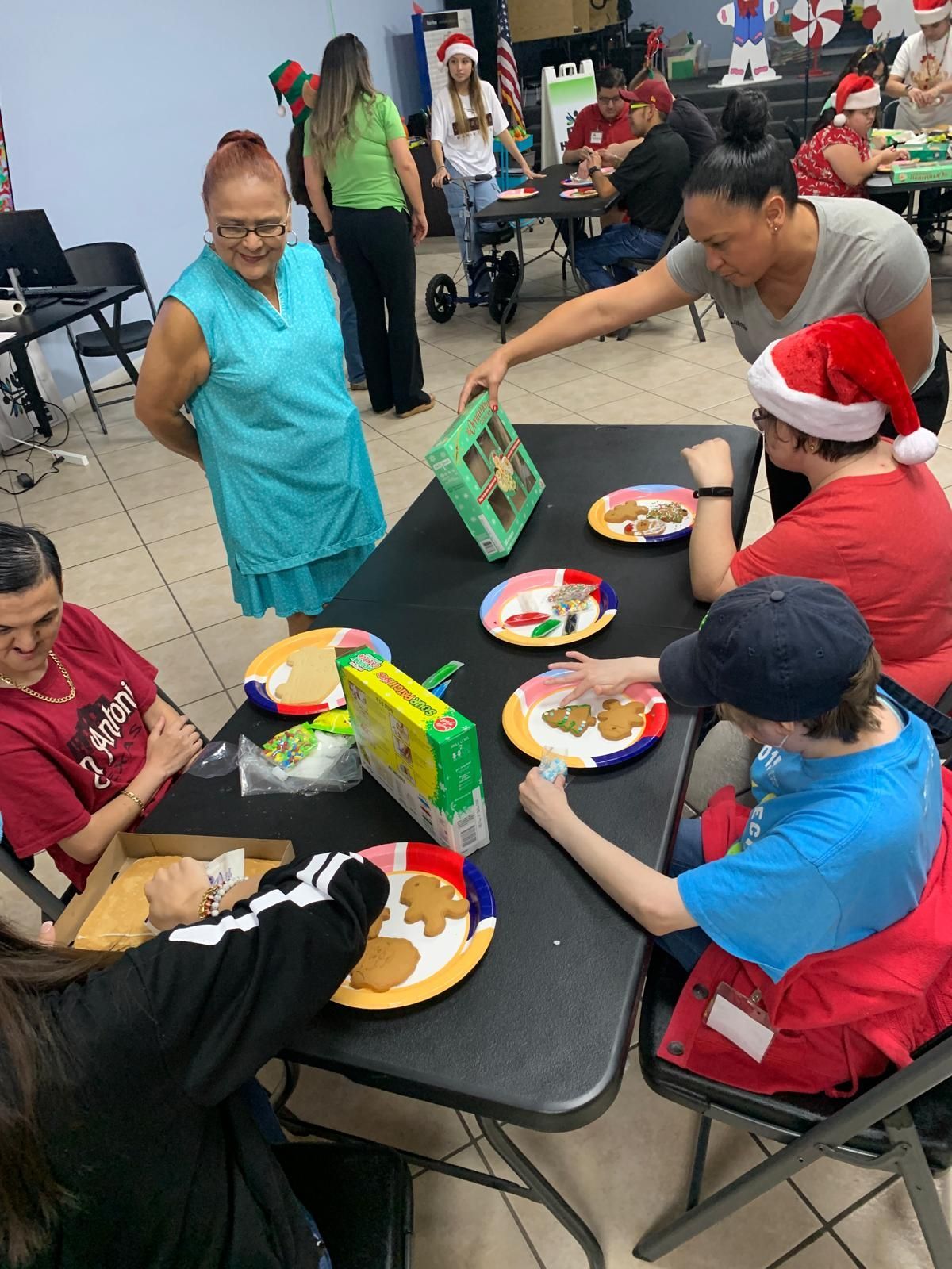 A group of people are sitting around a table with plates of food.