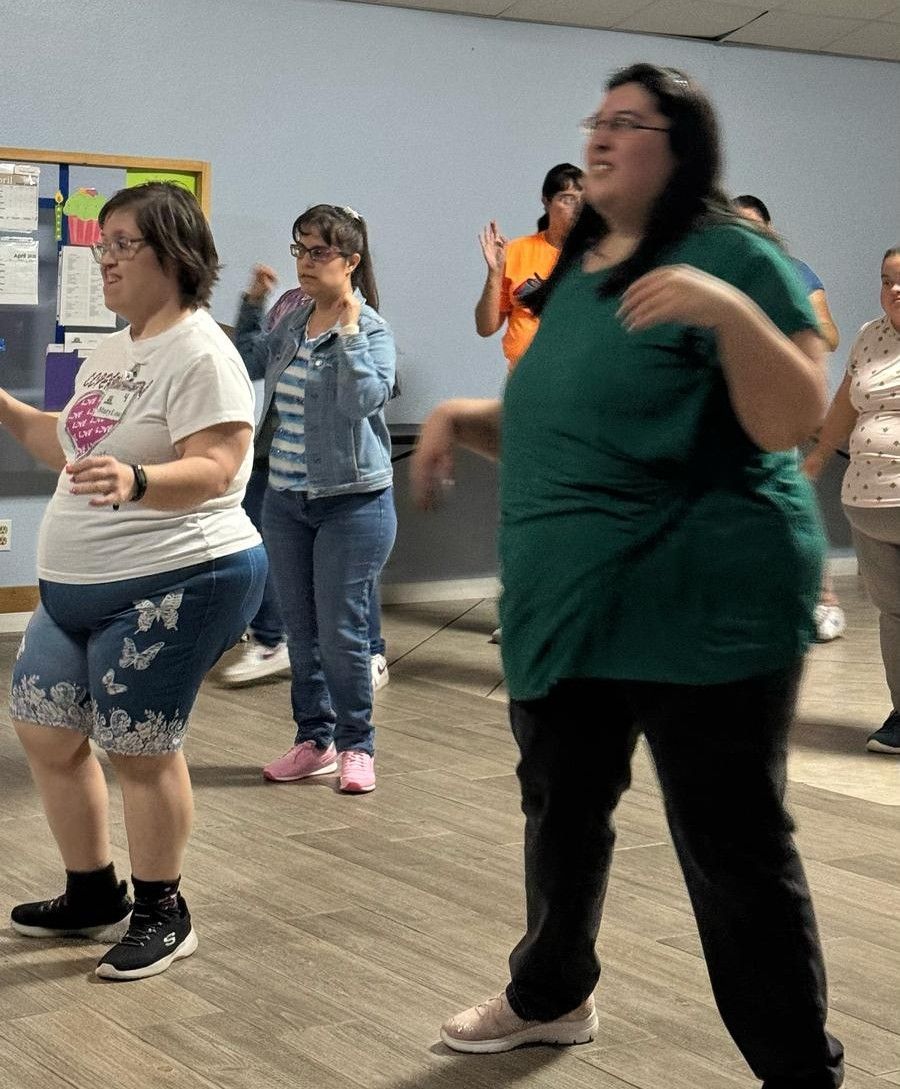 A group of women are dancing together in a room