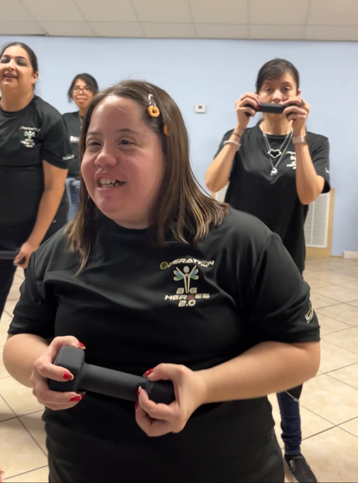 A woman wearing a black shirt with the number 26 on it