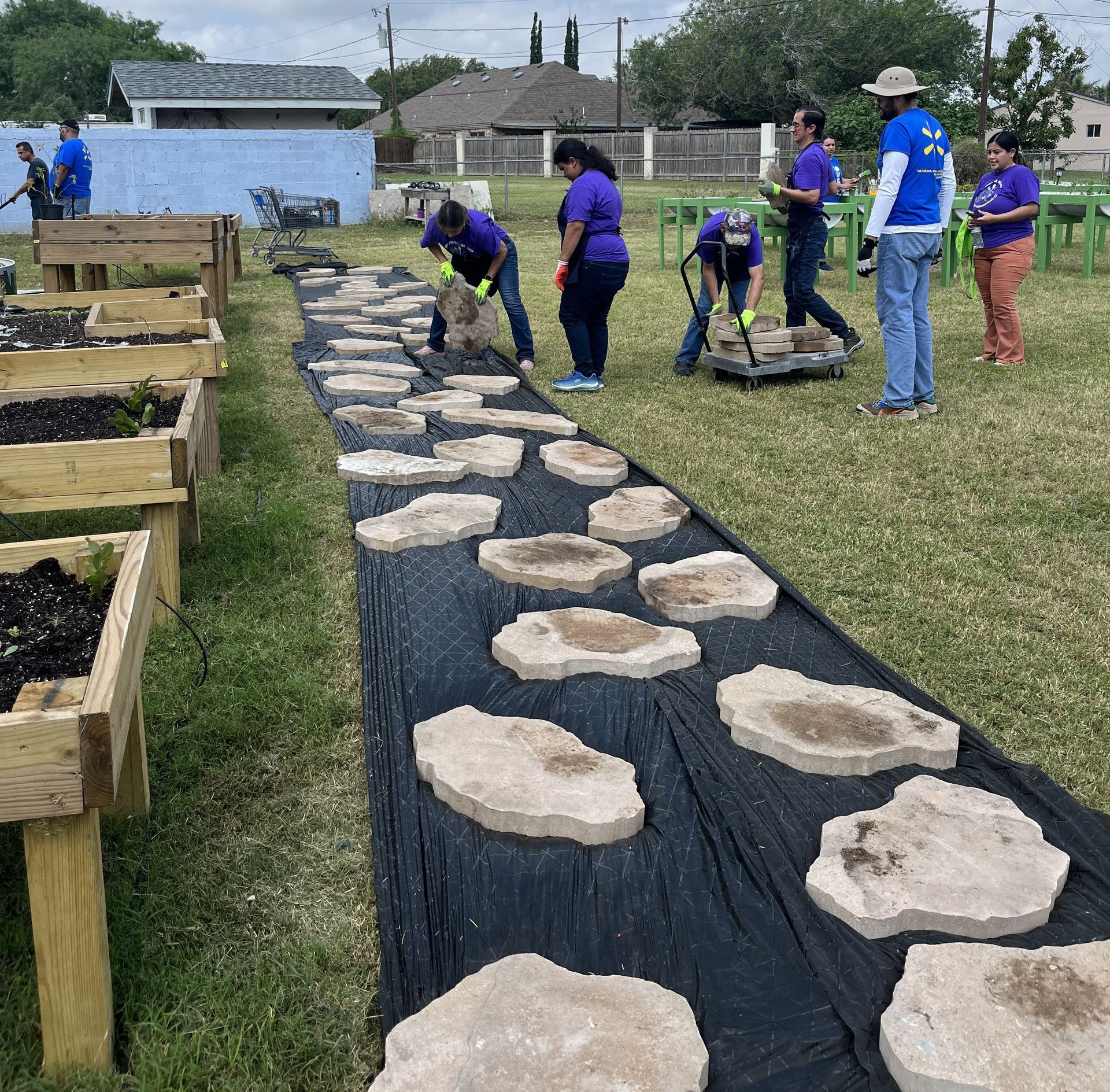 A group of people are working on a path of rocks