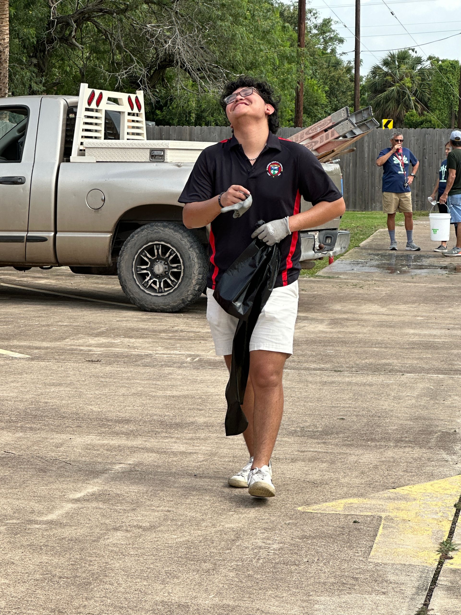 A man is walking in a parking lot next to a truck.