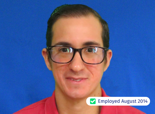 A man wearing glasses and a red shirt was employed in august 2014