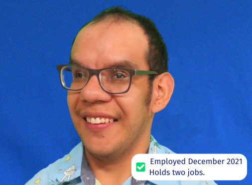 A man wearing glasses and a blue shirt has been employed since december 2021