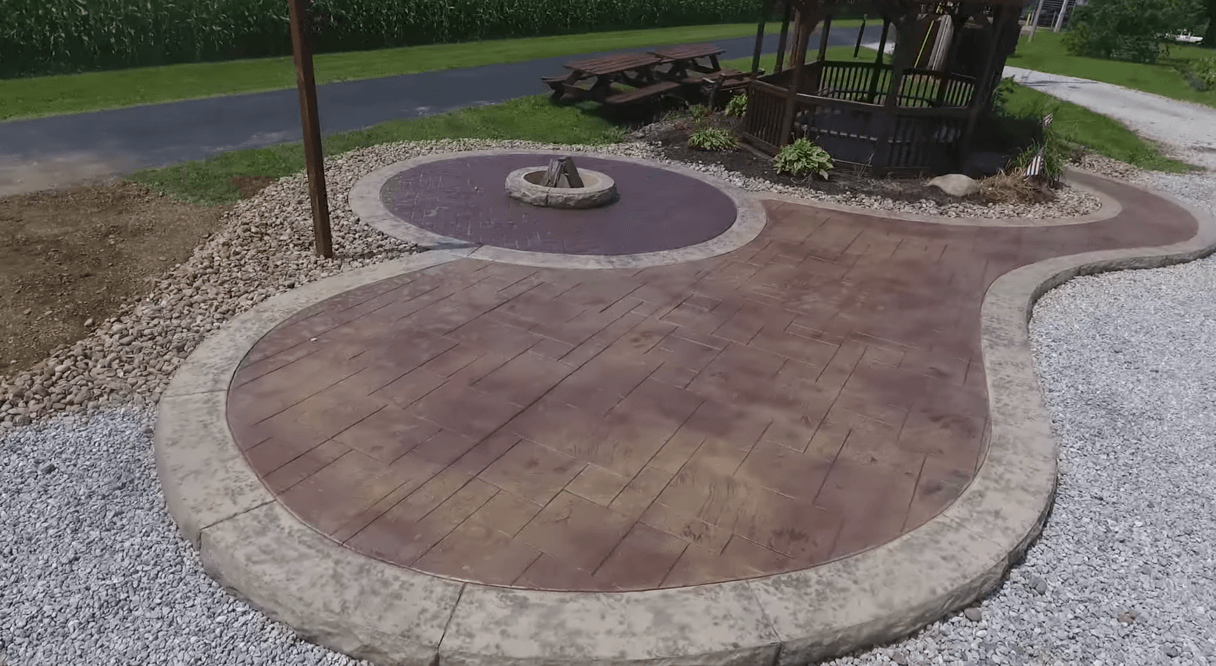 concrete contractors have paved a concrete driveway in front of a residence