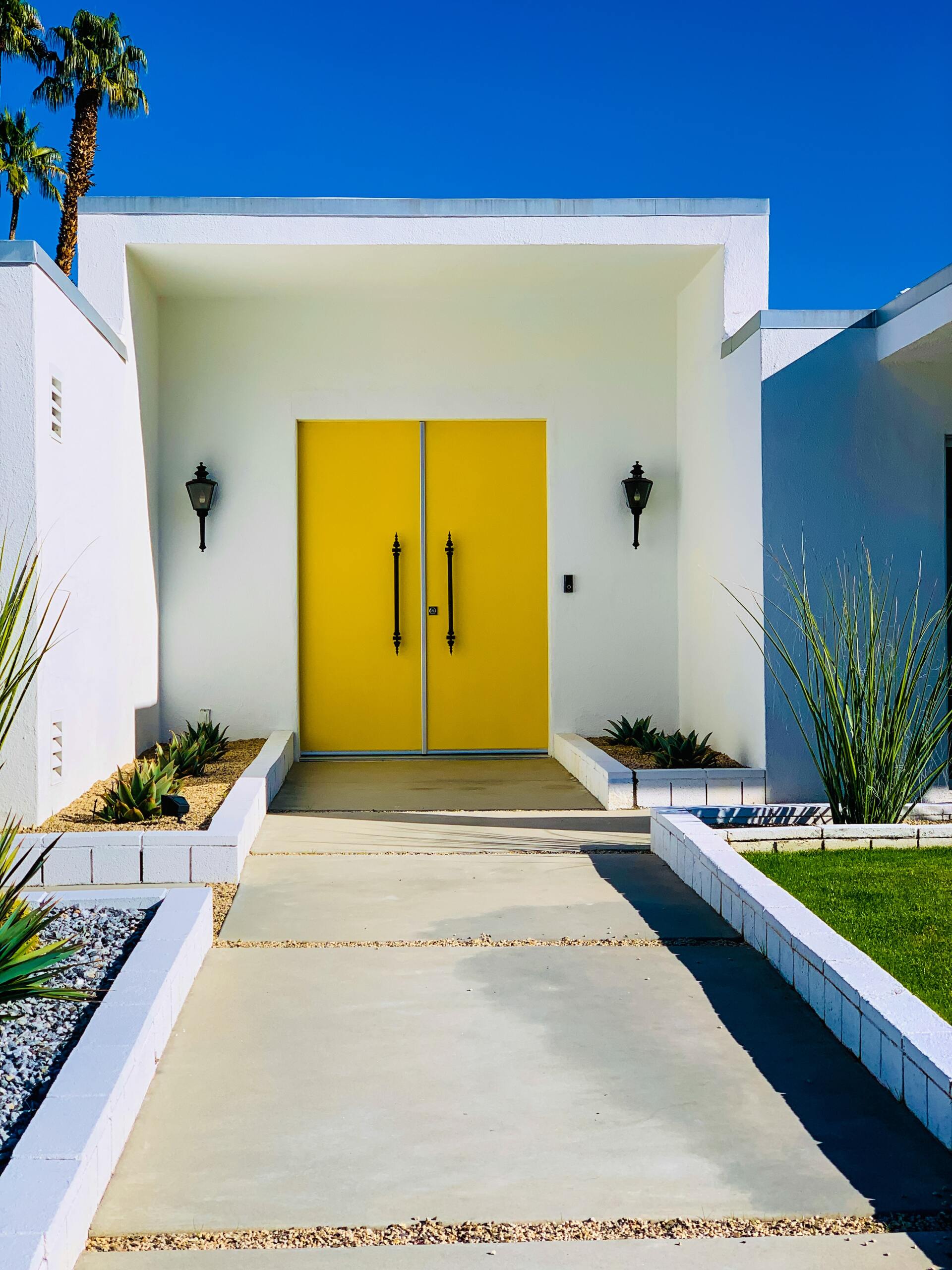a concrete slab walkway in front of a home in California