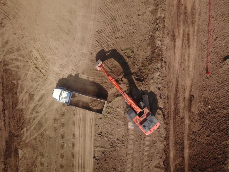 An aerial view of a construction site with a bulldozer and a truck.