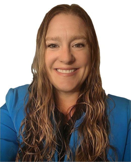 Woman with long blonde hair, smiling, wearing a tan blazer against a black background.
