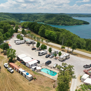 An aerial view of a campground with a lake in the background