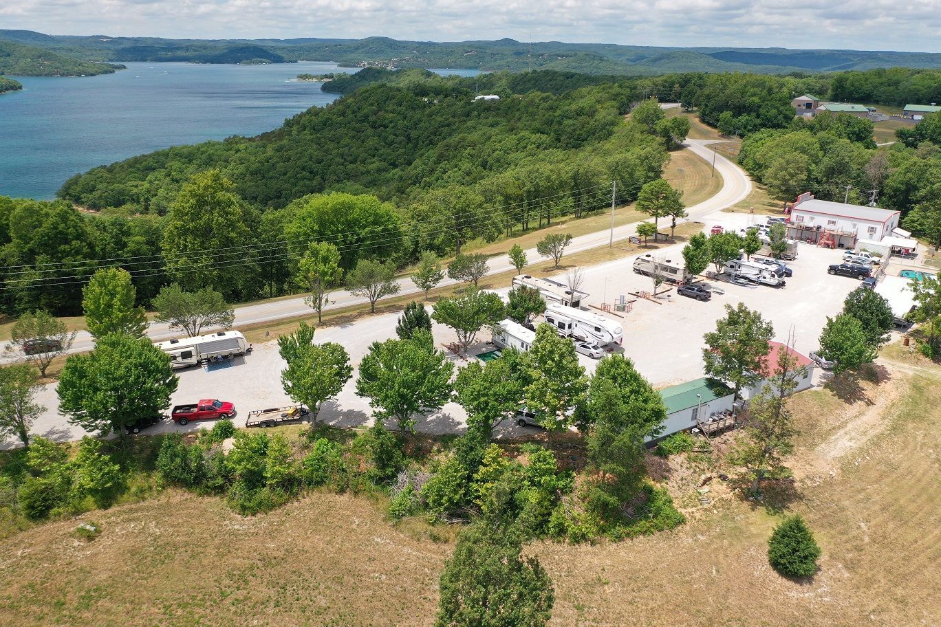 An aerial view of a parking lot with a lake in the background.