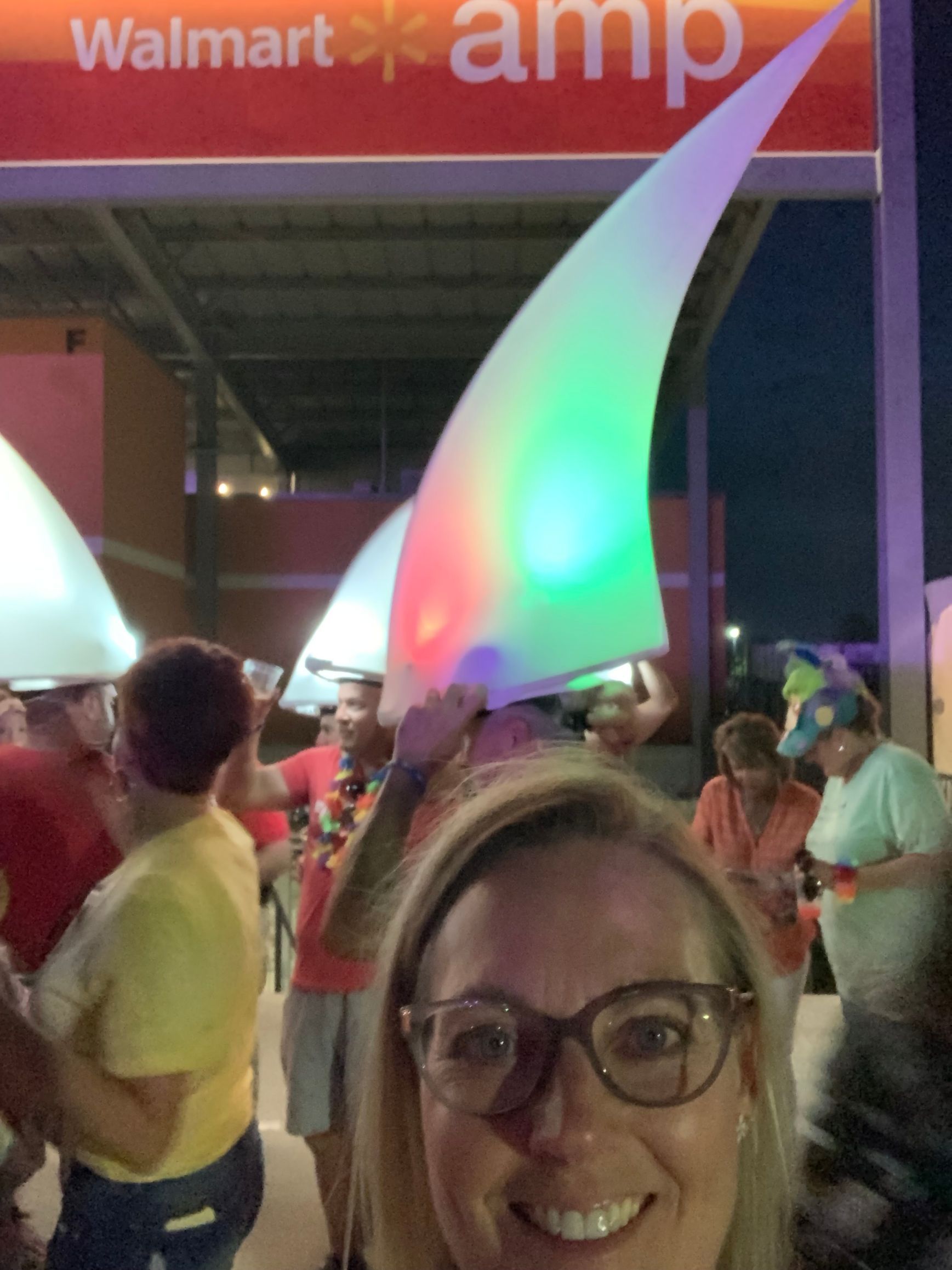 A woman wearing glasses is standing in a Jimmy Buffet tribute.