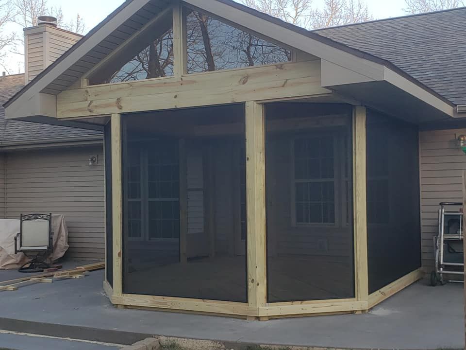 A screened in porch is being built on the side of a house located in Covington, IN.
