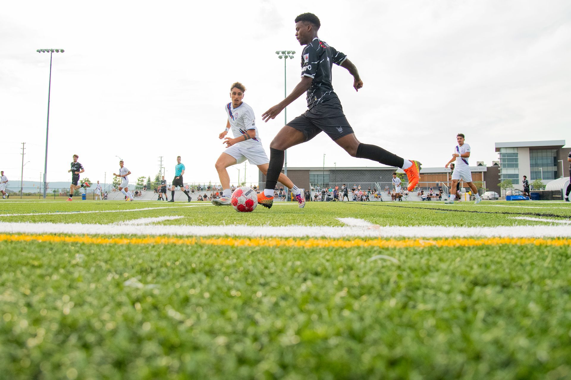 Scrosoppi FC player striking the ball during an Ontario Premier League match at St Francis Xavier in Milton, Ontario