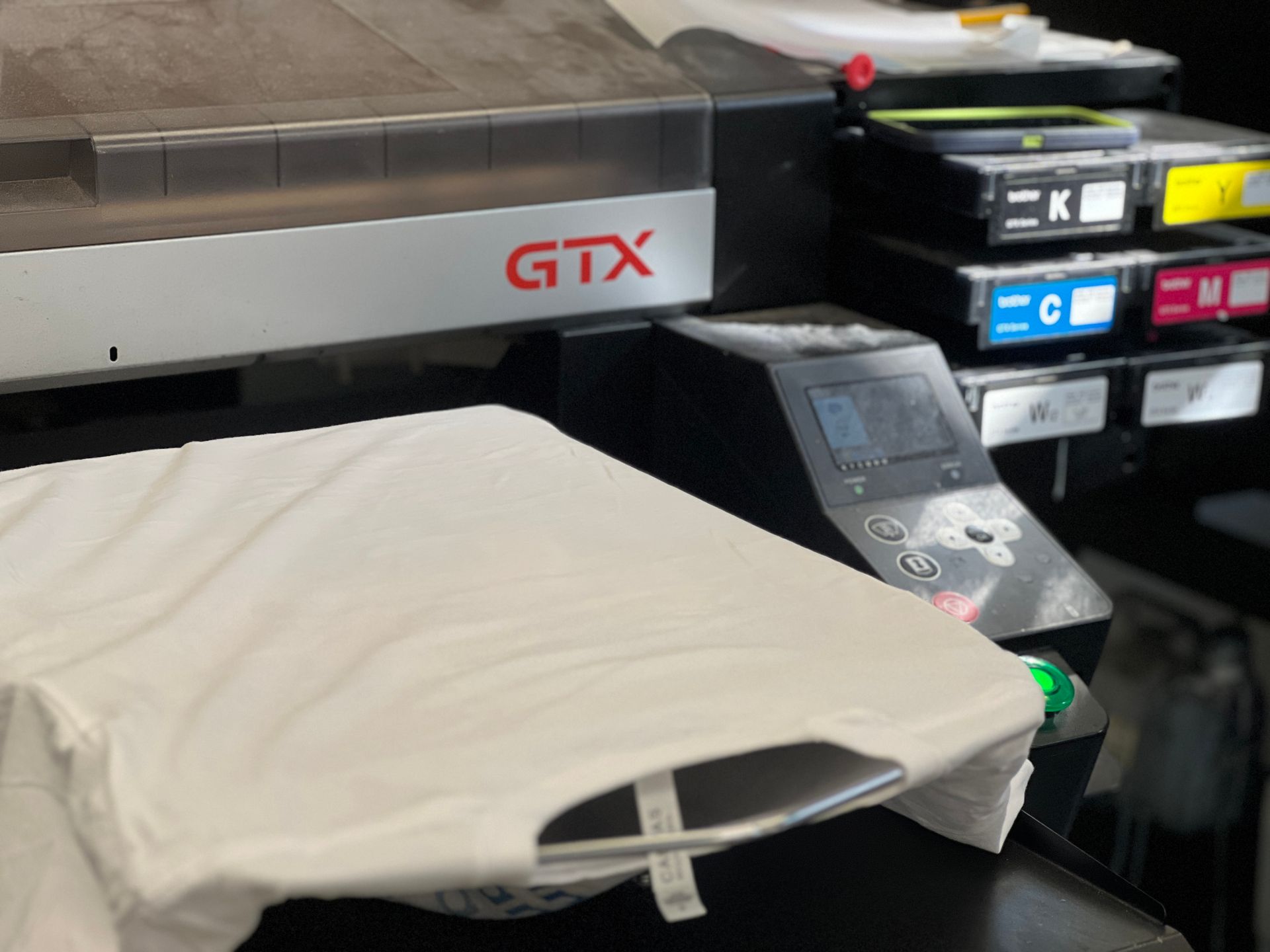 Image of a Direct to garment print machine with a white t-shirt n it