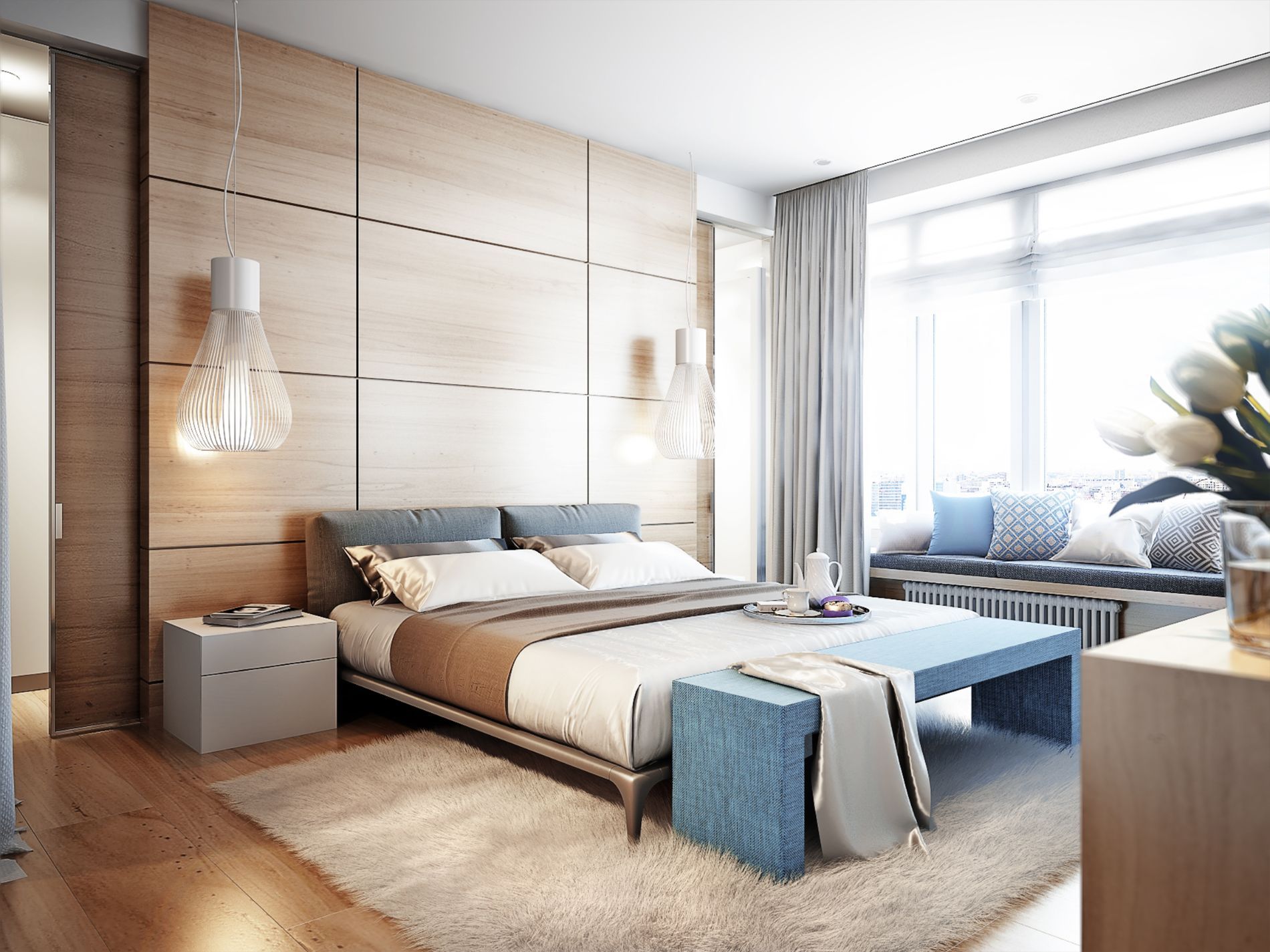 Camera da letto moderna con parete rivestita in legno, letto, seduta vicino alla finestra e lampade a sospensione. Colori tenui: beige, blu e bianco.